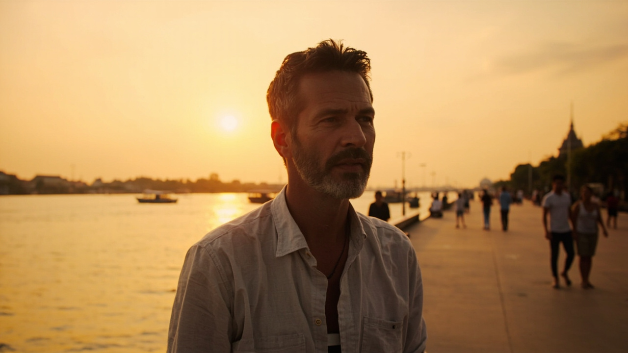 American traveler watching a golden sunset over the Phnom Penh riverfront promenade along the Tonle Sap river